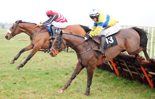Asitsohappens and Davy Russell (far-side) jump the last hurdle with Macnicholson 