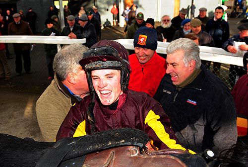 A delighted Shane Hassett unsaddles Do Be Doin' with his uncle Martin in the background