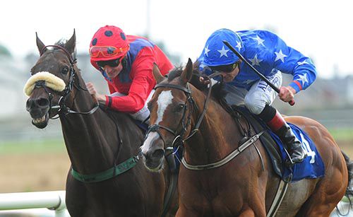 Hunting Tower (right) completes a treble for Pat Smullen