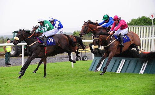 Atan (blue with green cap) jumps the last in fourth as Lady Clitico leads