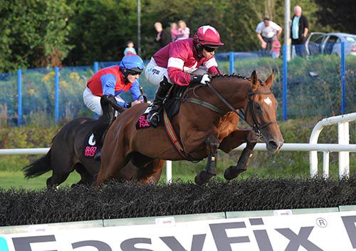 Rough Justice and Jonathan Burke clear a flight on their way to victory