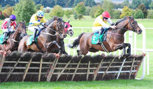 Sang Tiger, red cap, leads jumping the last in Navan