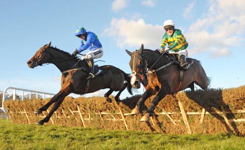 Hurricane Fly, left, jumps the last with Jezki