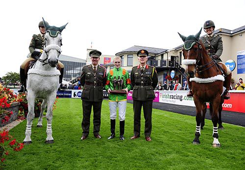 Members of the Defence Forces present Billy Lee with his prize