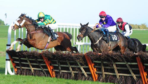 Luimneach Abu (left) leads Redwood Boy over the final hurdle