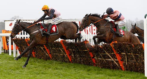 Polly Peachum and David Bass winning The 32Red com Mares Hurdle from The Govaness black cap at Sandown