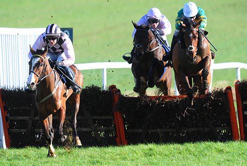 Winner Swamp Fox (David Mullins, centre) jumps the last in third behind Never Again and Cradle Mountain