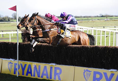 Kylemore Lough (near side) and Outlander jump the last together