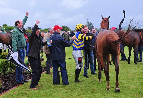 Members of the South East Racing Club celebrate the win of St Lawrence Gap
