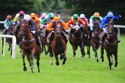 Shake The Bucket, left, and Slippers Madden lead into the straight