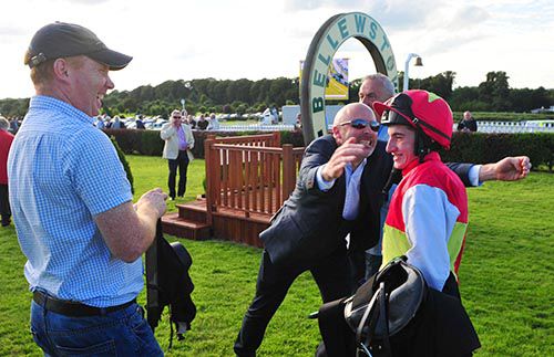 Killian Leonard is about to be mobbed by owner Simon Mulvany as Garvan Donnelly looks on
