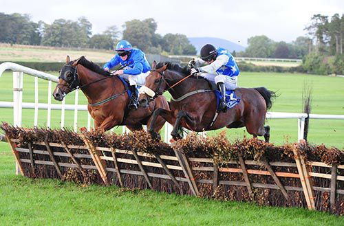 Native Lass (near side) and Rock On Bach jump the last