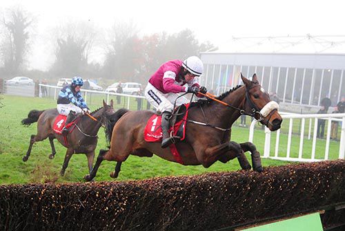 A Toi Phil leaps over the final fence in Punchestown