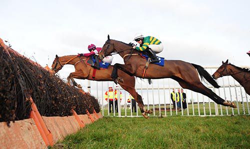 Teacher's Pet and Luke Dempsey take off at a hurdle