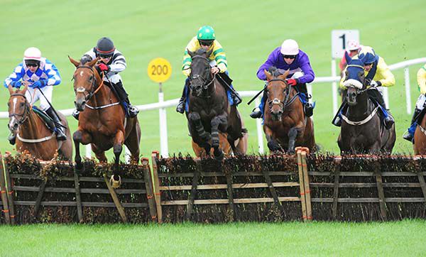 Guitar George (second from left) jumps the last in front