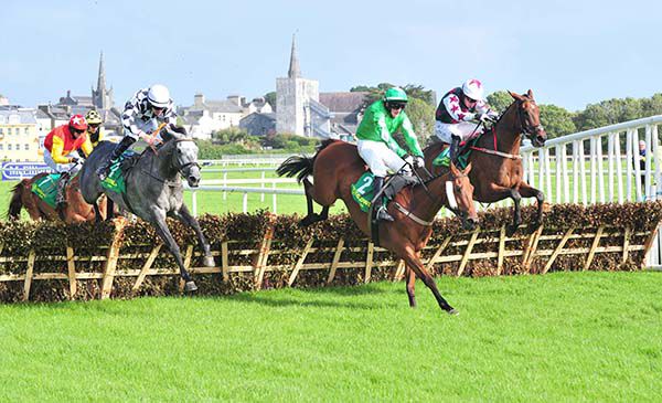 The grey Silver Planeur jumps the last in second with Open To The World leading