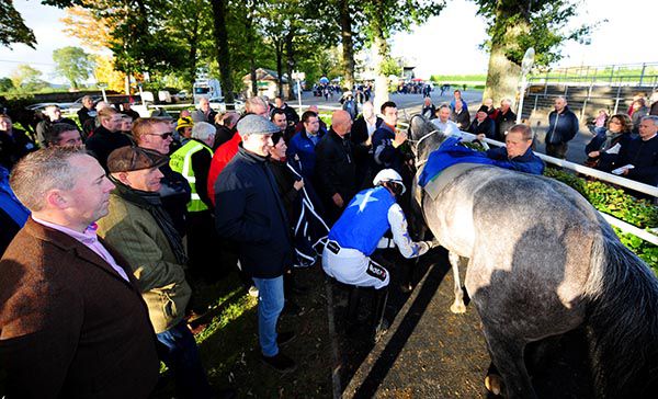 Patrick Mullins is surrounded by members of the Supreme Horse Racing Club after the success of Ainsi Va La Vie
