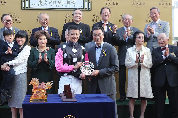 Derek Leung receiving at Trophy from Steward of HK Jockey club Michael TH Lee 