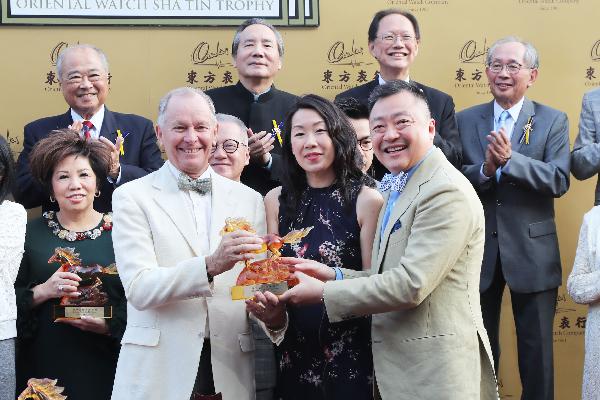 John Moore (receiving trophy) is one of the nine trainers