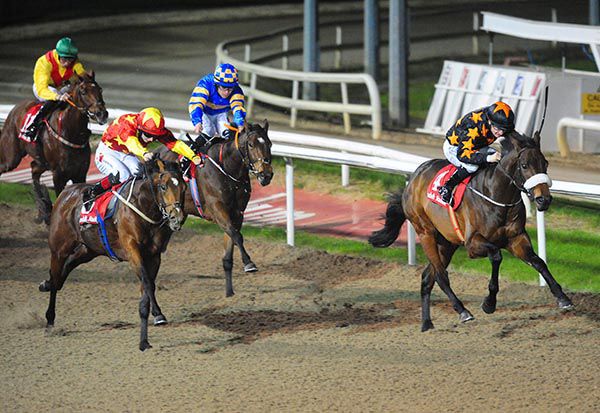 Red and yellow Colin Keane comes to beat Loving A Boom (Shane Foley), aboard winner, Overcoming