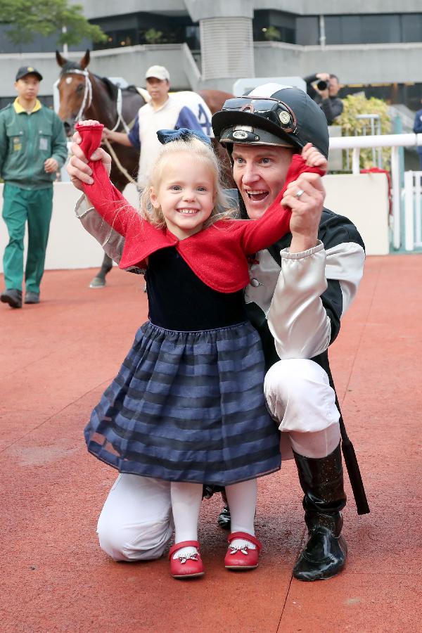 Zac Purton celebrates his win aboard Exultant (formerly Irishcorrespondent) with daughter Roxy at Sha Tin