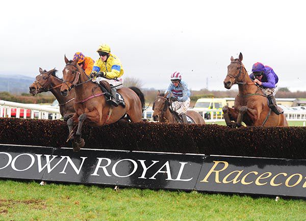 Yellow and blue silks Andrew Ring clears the last on winner, Blue Empyrean (cheek-pieces)