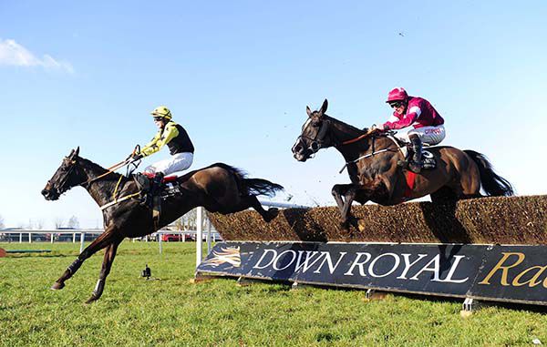 Crosshue Boy and Harley Dunne lead over the last fence from Fire In His Eyes