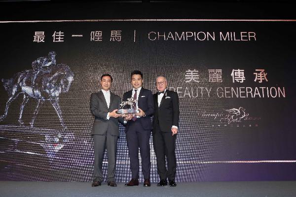 Michael T H Lee of HKJC presents the Champion Miler trophy to Patrick Kwok Ho Chuen owner of Beauty Generation