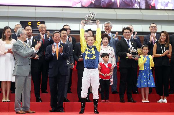 Zac Purton celebrates his second Champion Jockey title.