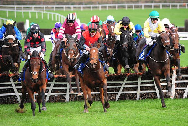 Messie, black and yellow striped cap, chases the leaders