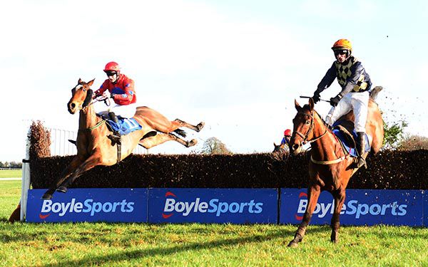 Loch Luatha and Daniel Holden (left) jump the last to beat Gunfire Reef (right)
