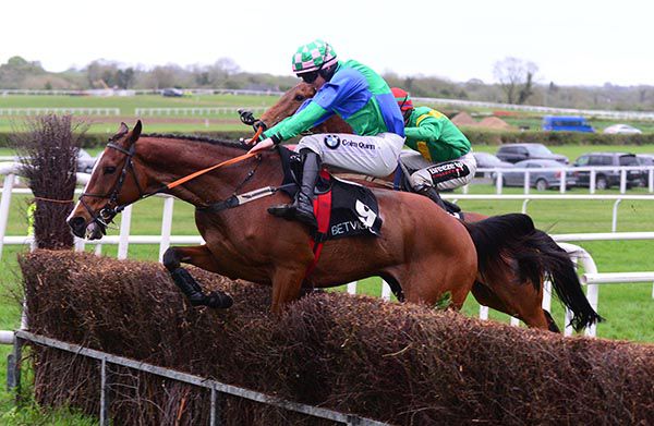 Stoughan Cross (Donagh Meyler) jump ahead of Bellgrove (J J Slevin, mainly hidden)