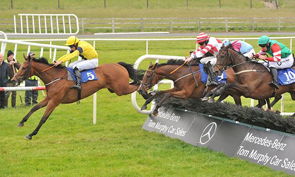 Rathnaleen Tou and Eamonn Corbett (centre red and white) chase Pakie's Dream over the last