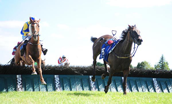 Global Racing, left, clears the last on his way to victory