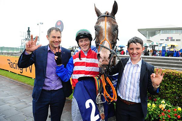 Mathew Smith, his son James and Billy Lee with One Cool Poet after winning for the third time at Galway
