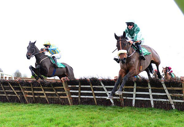 Alfa Mix (left) tackles long-time leader Drumacoo 