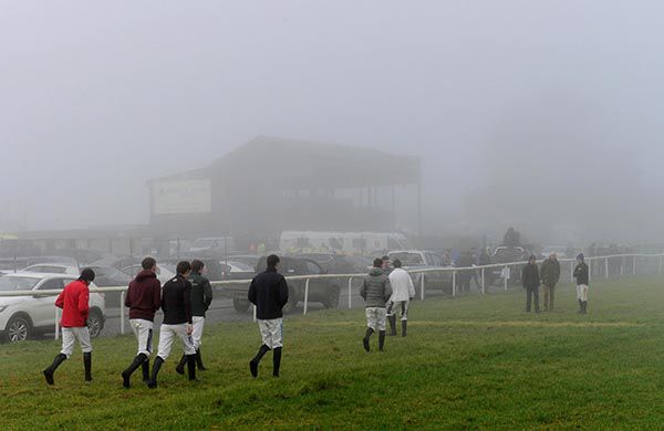 Jockeys walking the track at a Foggy Thurles Racecourse 