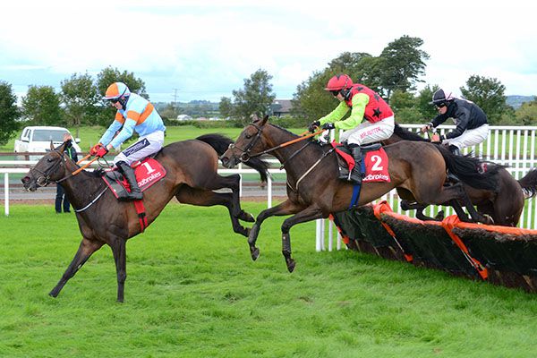 Presenting Meghan and Jonathan Moore (2) jump the last before overhauling Bioverdia (left)