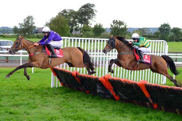 Trickey Trix and Conor Maxwell (left) jump the last ahead of Thatbeatsbanagher