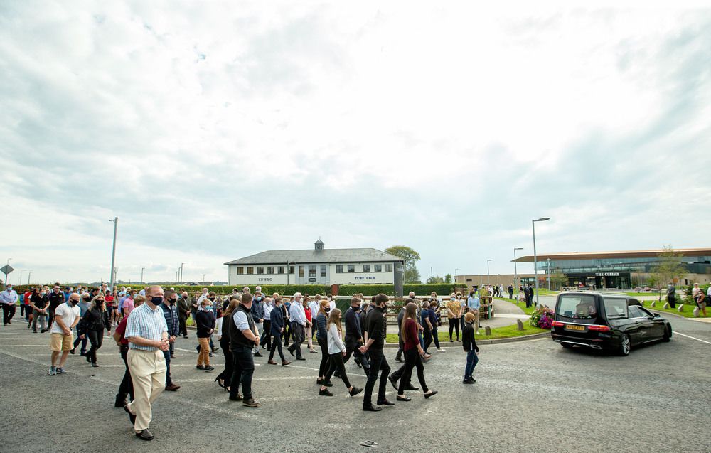 Crowds follow Pat Smullen's hearse at the Currgah Racecourse today(INPHO Tommy Dickson)