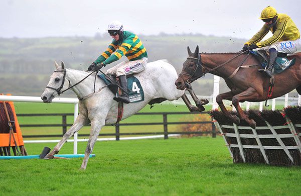 Elimay (Mark Walsh) leads eventual winner Buildmeupbuttercup (Paul Townend) over the last