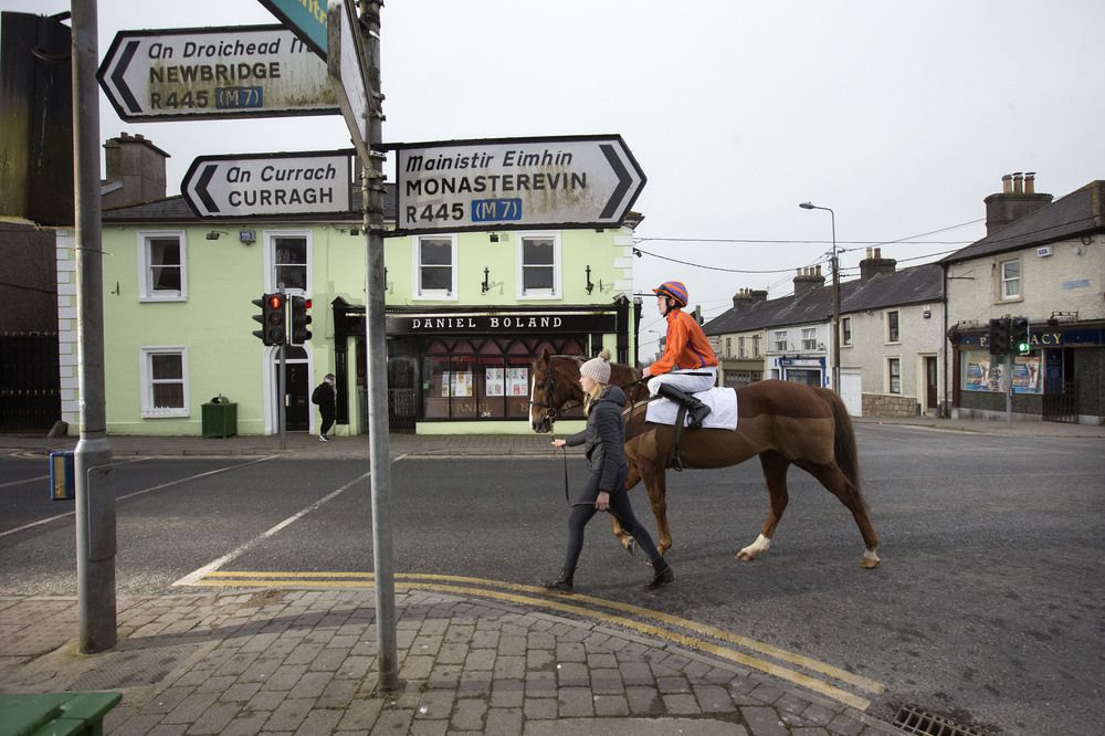 Heidi Brabazon leading Korbous & Tim Carroll through the streets of Kildare on the way to the Curragh Training Grounds