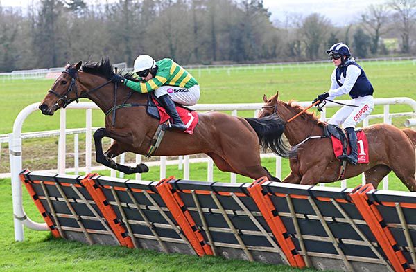 Dreamsrmadeofthis and Mark Walsh (left) jump the last in front of Fraternity