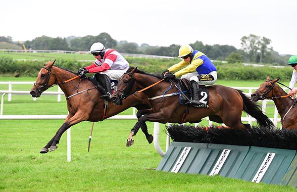 Darkened and Denis Hogan (near side) challenge at the last
