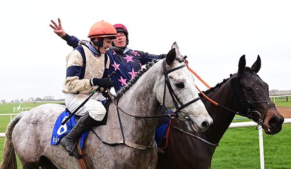 Davy Russell salutes Paul Townend who completed his treble on the grey Hi Ho Phoenix
