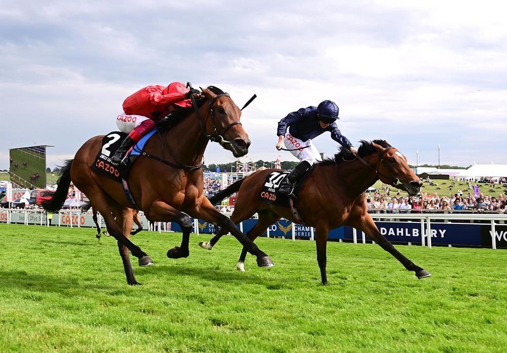 Tuesday (right) and Emily Upjohn flash past the post at Epsom
