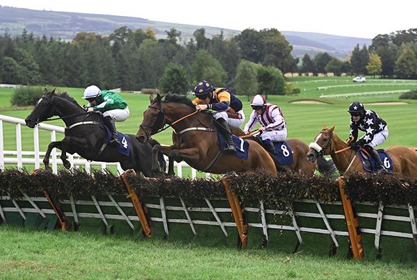Walking On Glass (left) and Aidan Kelly jumping the last
