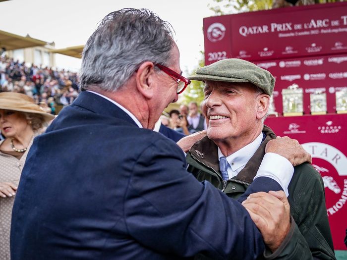 Sir Mark Prescott is congratulated by Vadeni's trainer Jean Claude Rouget after Alpinista's Arc victory 