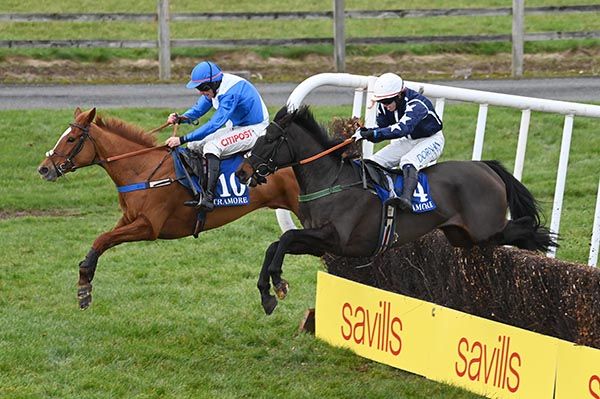 Indie Belle and Davy Russell (blue cap) jump the last with  Malinas Girl 