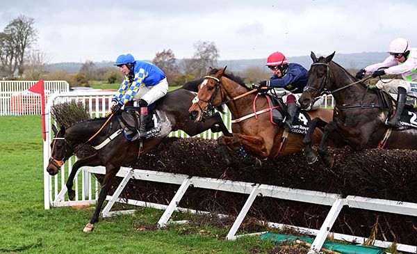 Longhouse Poet (centre) jumps the last with Roi Mage and Burrows Saint